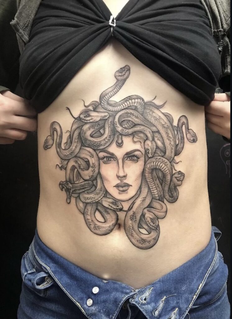 black and grey medusa on abdomen with shading