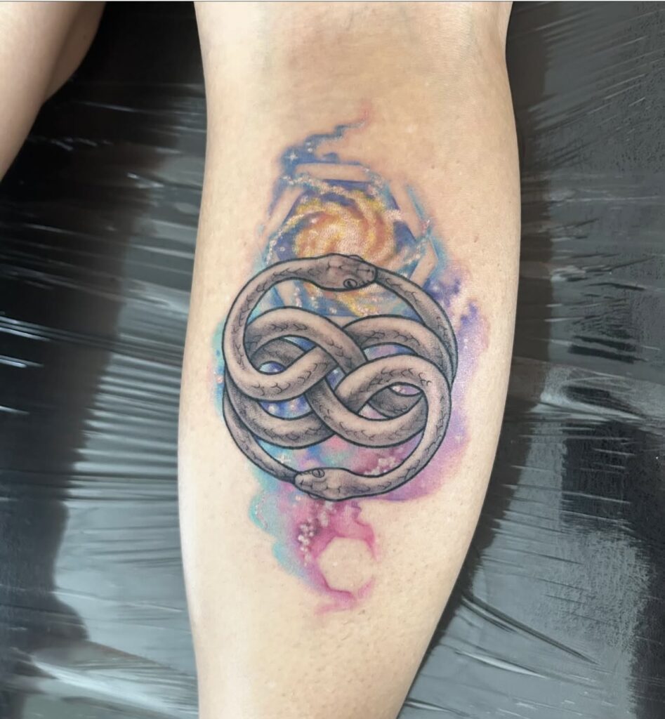 ouroboros in black and grey with watercolor galaxy