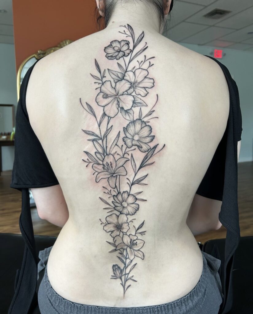 black and grey spine piece with flowers