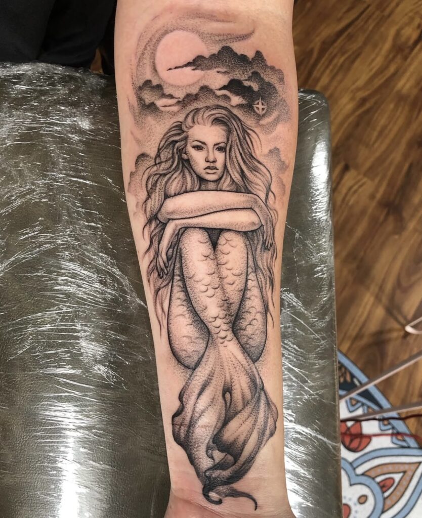 black and grey mermaid with pepper shading on inside forearm