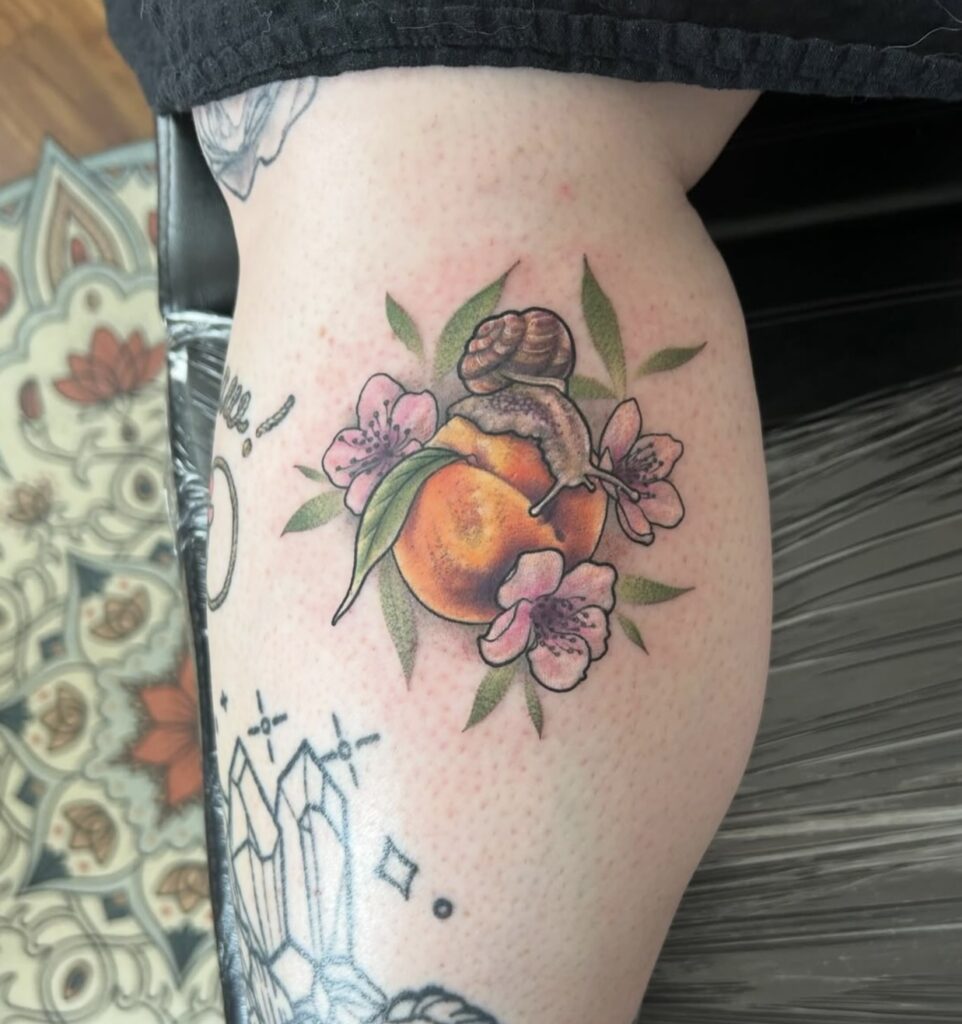 colorful peach, snail, and blossoms on calf